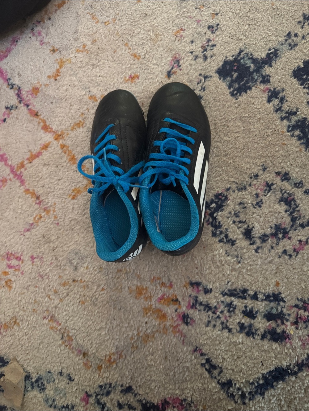 adidas Kids Black Soccer cleats with Blue Lining.